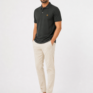 Man wearing a dark green polo shirt and beige pants on a white background