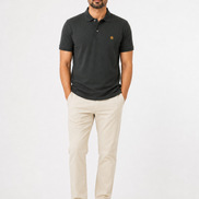 Man wearing a dark green polo shirt and beige pants on a white background