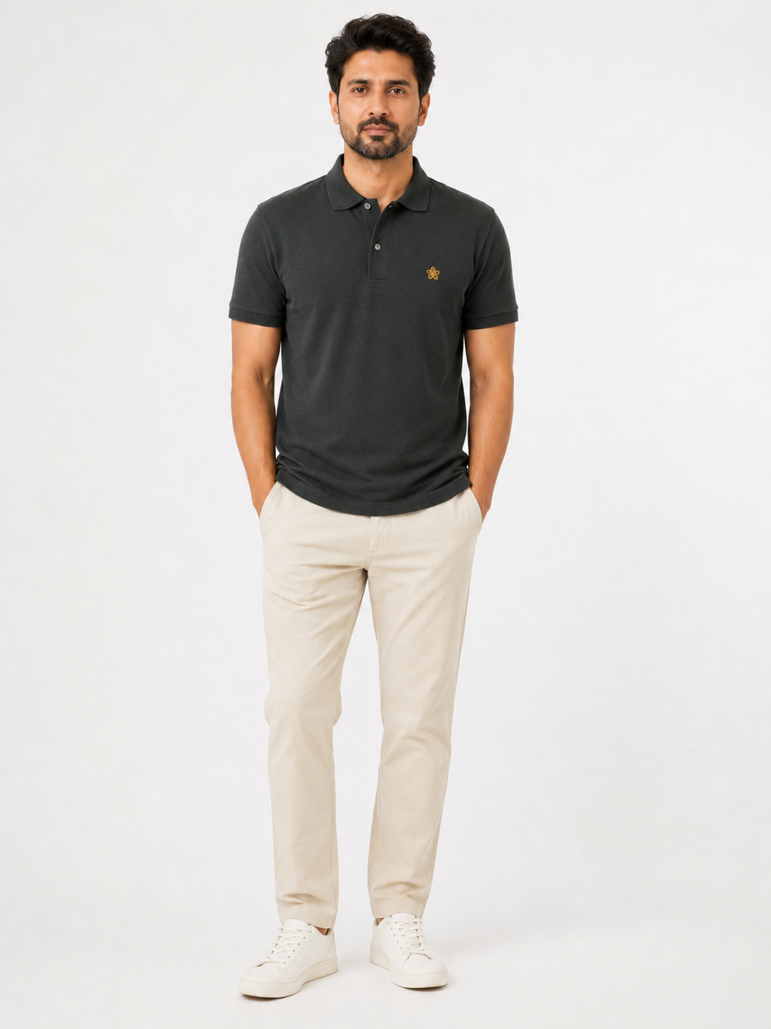 Man wearing a dark green polo shirt and beige pants on a white background