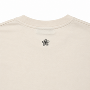 Cream t-shirt with a dark green embroidered Persimmon emblem design on a white background