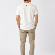 Man wearing a cream t-shirt and beige pants on a white background