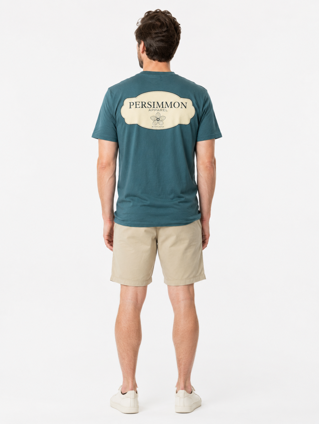 Man wearing a green t-shirt with Persimmon logo and beige shorts on a white background