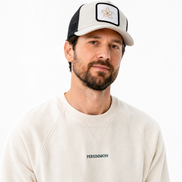 Man wearing a cap and a sweatshirt with 'Persimmon' branding on a white background