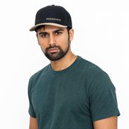 Man wearing a dark green t-shirt and black cap with 'Persimmon' branding on a white background
