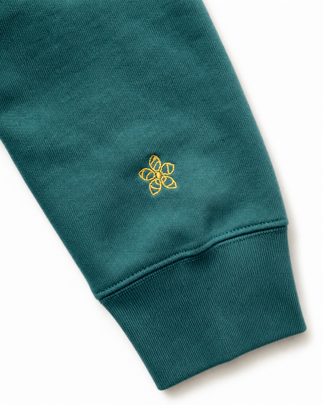 Green hoodie sleeve with a yellow embroidered Persimmon emblem design on a white background